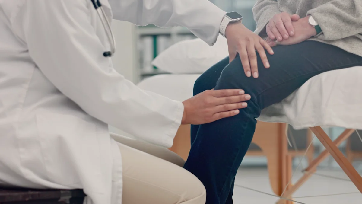 A clinician examining a patient at the ChiroMed treatment table